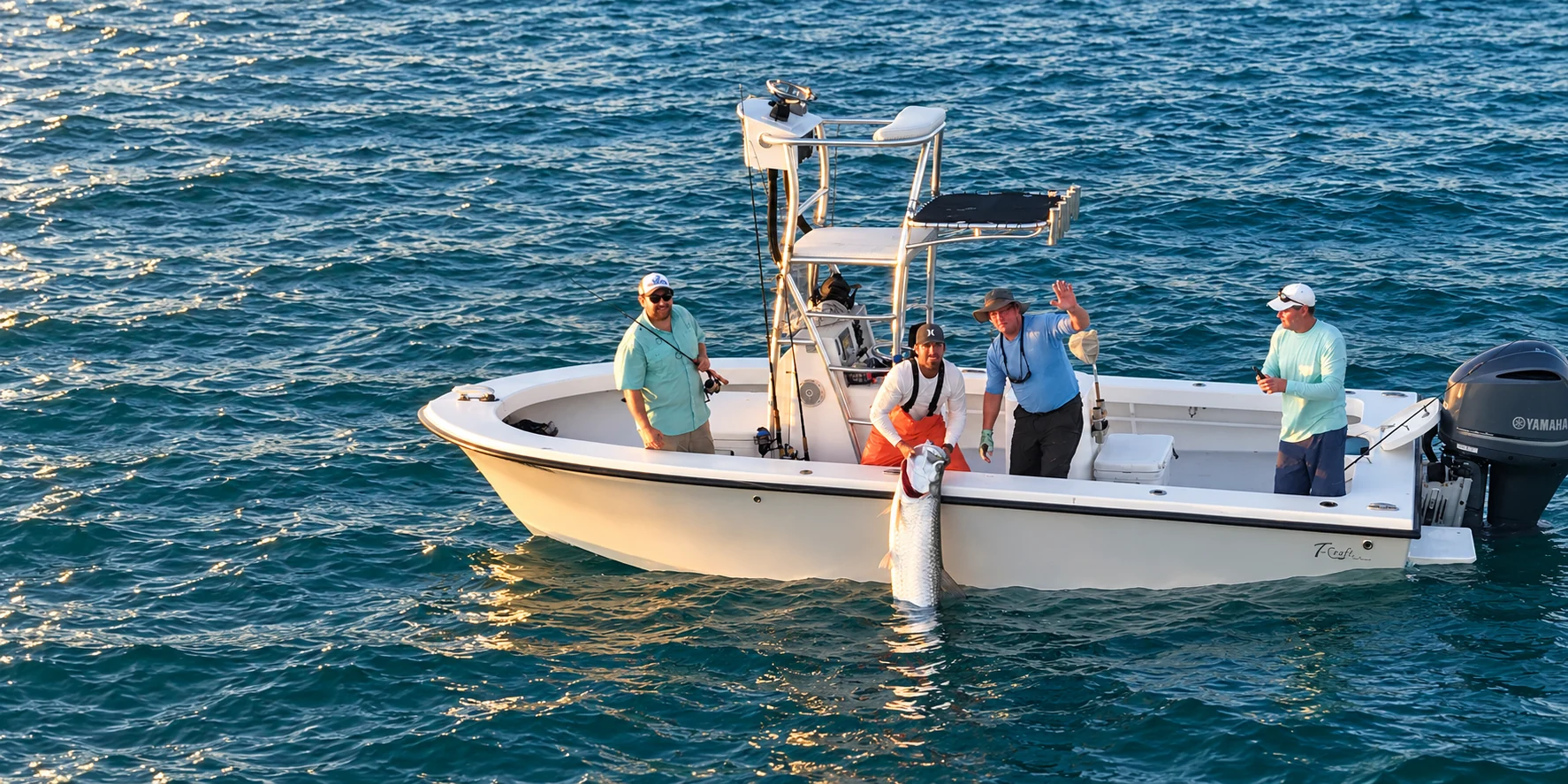 Anglers aboard the charter boat with their tarpon catch